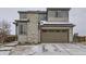 Two-story home featuring stone accents and an attached two car garage with well-maintained landscaping at 17265 E 110Th Ct, Commerce City, CO 80022