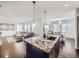 Open kitchen design with island seating, granite counters, and hardwood flooring at 17265 E 110Th Ct, Commerce City, CO 80022
