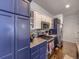 Modern kitchen features stainless steel appliances, blue cabinets, and stylish backsplash at 17265 E 110Th Ct, Commerce City, CO 80022