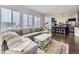 Open-concept living room featuring a large sectional sofa, modern finishes, and natural light at 17265 E 110Th Ct, Commerce City, CO 80022