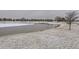 Scenic view of a partially frozen pond in a residential area at 17265 E 110Th Ct, Commerce City, CO 80022