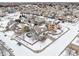 Two-story house with backyard, aerial view of snow-covered neighborhood at 5008 S Nepal St, Centennial, CO 80015