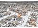 Aerial view of a two-story house in a snow-covered neighborhood at 5008 S Nepal St, Centennial, CO 80015