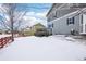 Snowy backyard with a deck and a view of neighboring homes at 5008 S Nepal St, Centennial, CO 80015