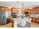 Island kitchen with stainless steel appliances and granite counters at 5008 S Nepal St, Centennial, CO 80015