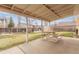 A covered back patio with concrete flooring provides an outdoor space for relaxing and enjoying the backyard at 1410 S Grant St, Longmont, CO 80501