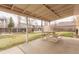 A covered back patio with concrete flooring provides an outdoor space for relaxing and enjoying the backyard at 1410 S Grant St, Longmont, CO 80501