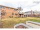 Backyard featuring metal planter beds and a covered patio, surrounded by green lawn and fencing at 1410 S Grant St, Longmont, CO 80501