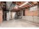 Unfinished basement with exposed ceiling, water heater, shelves, and concrete floors, ready for customization at 1410 S Grant St, Longmont, CO 80501