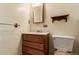 Cozy bathroom featuring oak vanity, classic mirror, and neutral decor at 1410 S Grant St, Longmont, CO 80501