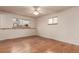 Well-lit bedroom featuring hardwood floors, a ceiling fan, and ample natural light at 1410 S Grant St, Longmont, CO 80501