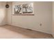 Carpeted bedroom featuring a modern light fixture and a large window providing natural light at 1410 S Grant St, Longmont, CO 80501