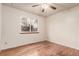 Bedroom features hardwood floors, large window and neutral walls at 1410 S Grant St, Longmont, CO 80501