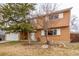 Charming exterior of home featuring mature trees and manicured lawn at 1410 S Grant St, Longmont, CO 80501