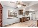 Eat-in kitchen featuring wood cabinets, a large window, and a ceiling fan at 1410 S Grant St, Longmont, CO 80501