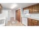 Bright kitchen with oak cabinets and white appliances, offering ample storage space at 1410 S Grant St, Longmont, CO 80501