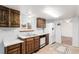 Well-lit kitchen featuring wood cabinetry, a double sink, and modern appliances at 1410 S Grant St, Longmont, CO 80501