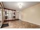 Bright living room with adjacent kitchen and entry, featuring tile floors at 1410 S Grant St, Longmont, CO 80501