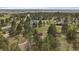 An aerial view highlights a home surrounded by mature trees in a private, serene community at 3337 Ponderosa Rd, Franktown, CO 80116