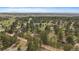 Aerial view of a home nestled among mature trees in a community with large lots and open spaces at 3337 Ponderosa Rd, Franktown, CO 80116