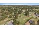 Expansive property featuring a home, several outbuildings, mature trees, and a large grassy yard at 3337 Ponderosa Rd, Franktown, CO 80116