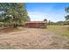 Exterior view of home featuring wood siding, red roof, small deck, and mature pines at 3337 Ponderosa Rd, Franktown, CO 80116