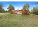 Exterior view featuring the back of the home and a wooden fence for privacy at 3337 Ponderosa Rd, Franktown, CO 80116