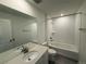 Bright bathroom features a shower-tub combination, modern fixtures, and ample vanity space at 9041 Redfield Ln, Parker, CO 80134