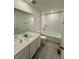 Bright bathroom with a single vanity with a quartz countertop, and a tub-shower combo at 9041 Redfield Ln, Parker, CO 80134