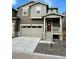 Charming two-story home featuring a neutral color scheme, a two-car garage, and a quaint front porch at 9041 Redfield Ln, Parker, CO 80134
