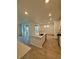 Contemporary kitchen with a large island, stainless appliances, and wood flooring extending to dining area at 9041 Redfield Ln, Parker, CO 80134