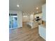 Bright, modern kitchen with stainless steel appliances, a large island, and sliding doors to the deck at 9041 Redfield Ln, Parker, CO 80134
