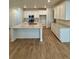 Well-lit kitchen featuring white cabinets, stainless steel appliances, a large island, and modern fixtures at 9041 Redfield Ln, Parker, CO 80134