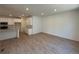 Open concept living room adjacent to kitchen with luxury vinyl plank flooring at 9041 Redfield Ln, Parker, CO 80134