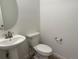 Clean powder room with pedestal sink, modern fixtures and hardwood style flooring at 9041 Redfield Ln, Parker, CO 80134