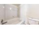 Well-lit bathroom showcases a soaking tub, toilet, and tiled walls at 3401 W 98Th Dr # C, Westminster, CO 80031