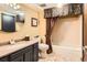 Clean bathroom with a tub, shower, and updated vanity at 6575 S Webster St, Littleton, CO 80123