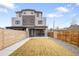 Exterior showcasing fenced backyard with lawn, a modern facade, and stylish gray and brick accents at 1953 W 47Th Ave, Denver, CO 80211
