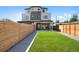 A modern home with a spacious fenced backyard and lush green grass at 1953 W 47Th Ave, Denver, CO 80211