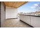 A covered balcony with decorative tile flooring, white siding, and black metal railings for added style and safety at 1953 W 47Th Ave, Denver, CO 80211