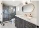 Elegant bathroom featuring a glass enclosed shower, stylish vanity, and modern fixtures at 1953 W 47Th Ave, Denver, CO 80211