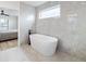 A luxurious bathroom features a soaking tub and large-format tile at 1953 W 47Th Ave, Denver, CO 80211