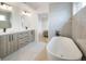 A luxurious bathroom features dual vanities and a freestanding tub at 1953 W 47Th Ave, Denver, CO 80211