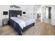 Inviting bedroom features neutral paint, hardwood floors, and access to other rooms in the home at 1953 W 47Th Ave, Denver, CO 80211