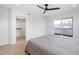Spacious bedroom with closet, light hardwood floors, ceiling fan, and sliding glass doors to a balcony at 1953 W 47Th Ave, Denver, CO 80211