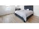 Serene bedroom with light hardwood floors, comfortable bed, and ample natural light at 1953 W 47Th Ave, Denver, CO 80211