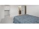 Bright bedroom featuring neutral carpet, open closet space, and ensuite bathroom with modern finishes at 1953 W 47Th Ave, Denver, CO 80211