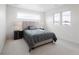 Bright bedroom with large windows, plush carpeting, and a comfortable, stylish bed frame at 1953 W 47Th Ave, Denver, CO 80211