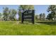 Chaffee Park entrance sign surrounded by lush green grass and trees under a clear blue sky at 1953 W 47Th Ave, Denver, CO 80211