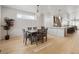 Dining room with modern table, chairs, decorative wainscotting, and view into the kitchen area at 1953 W 47Th Ave, Denver, CO 80211